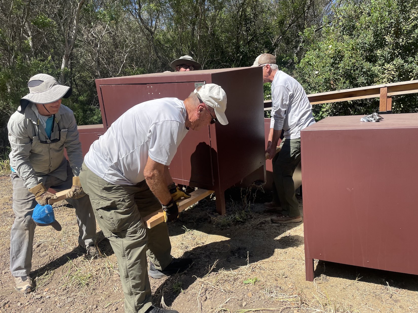 Moving a "fox box" to a tent pad site. George, Dave, John & Barry