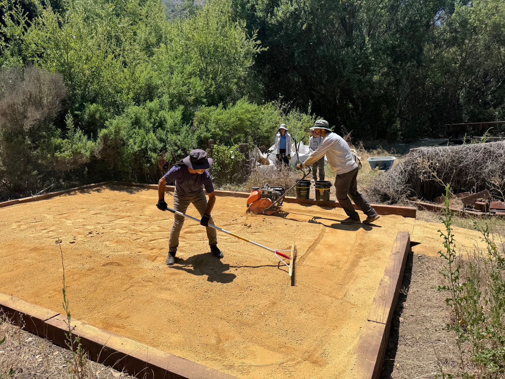 Juan & Peter preparing the decomposed granite for one of the tent pads 