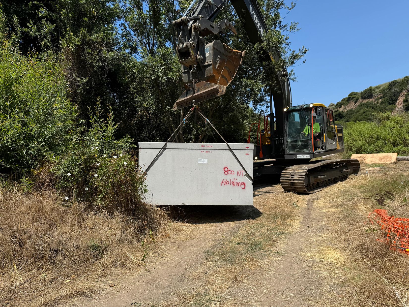 Moving the vault for the toilet into place